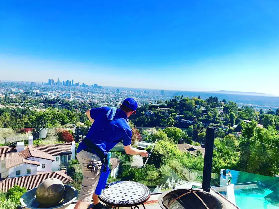 Technician cleaning ocean-view windows