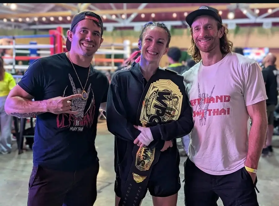 WPC Championship belt holder with Left Hand Muay Thai team after title win